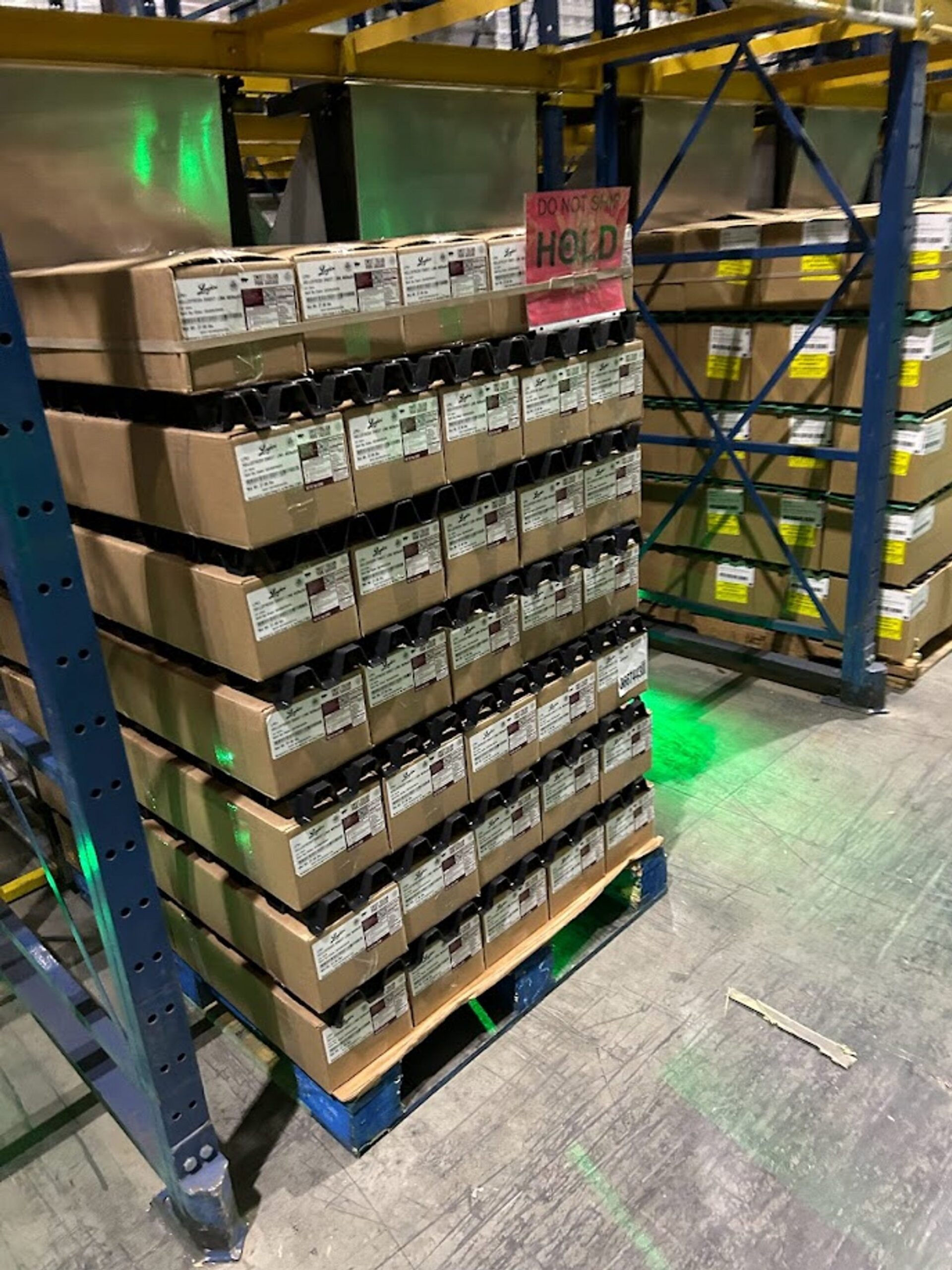 Pallets staged directly in front of a QFM, restricting airflow to the unit