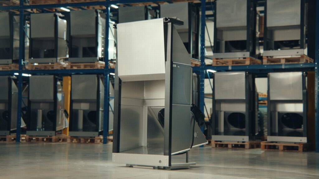 A QFM modular blast freezer unit with a line of units racked behind it